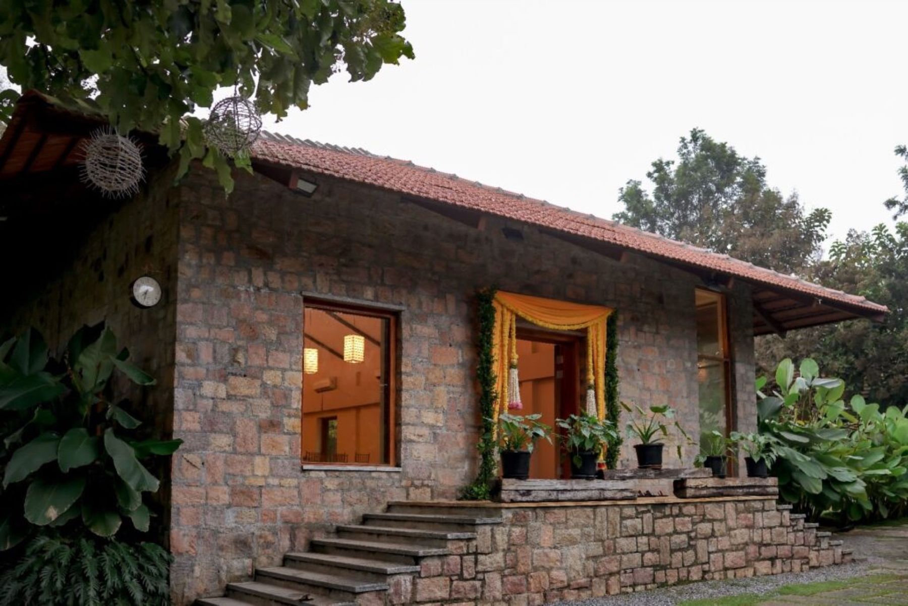 A stone cottage with a Mangalore clay-tile roof
