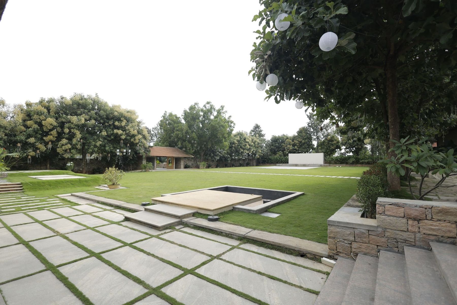 The main lawn with the sunken pond and stone paving