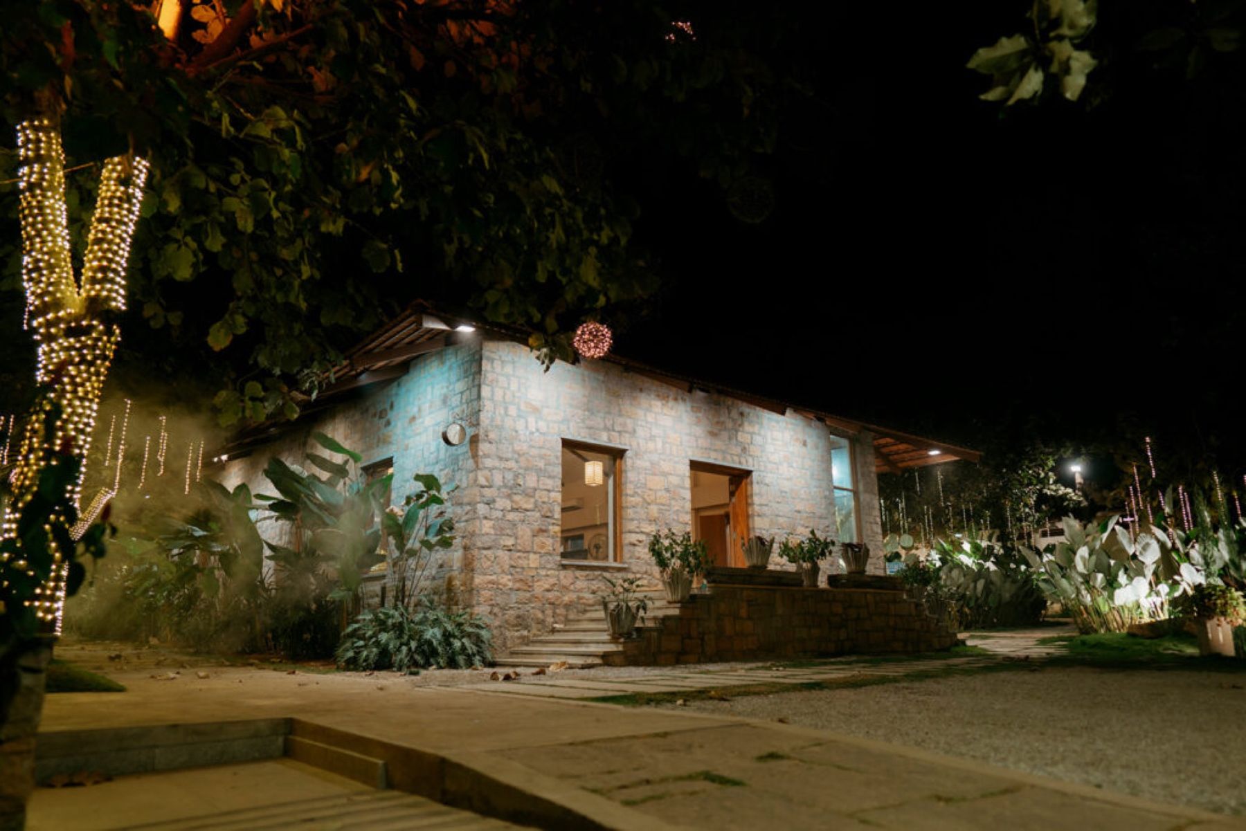 A stone cottage at night, in mist